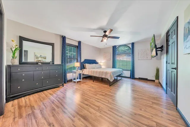 a spacious bedroom with a bed and a dresser