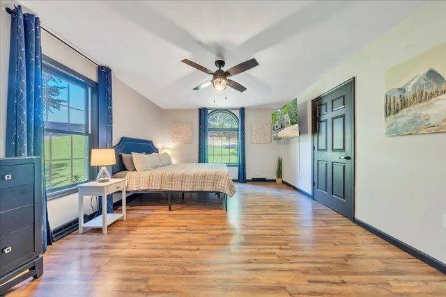 a bedroom with a bed and a large window