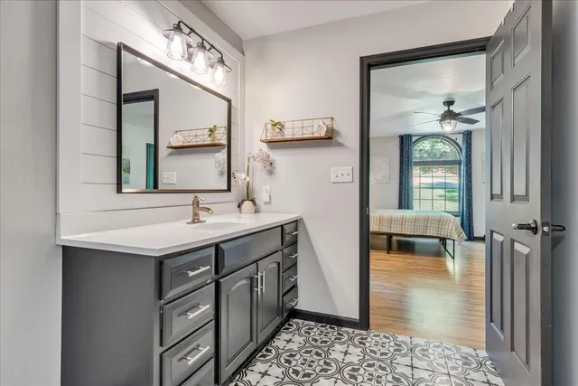 a bathroom with a sink a mirror and a shower