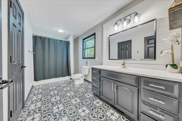 a bathroom with a double vanity sink and a mirror