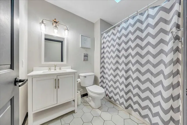 a bathroom with a sink toilet and mirror