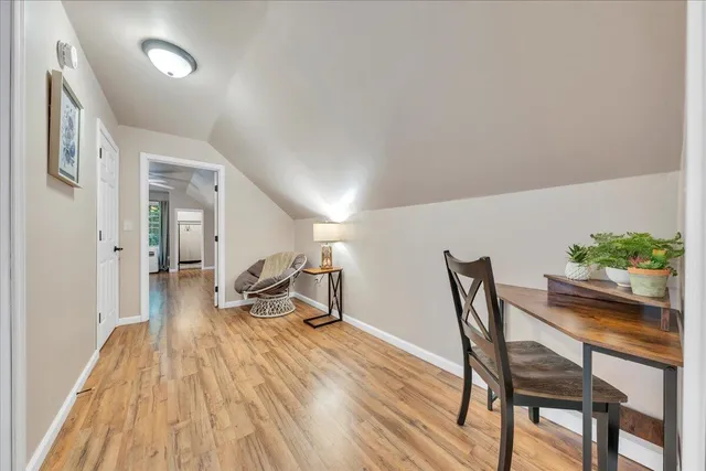 a dining room with furniture and wooden floor