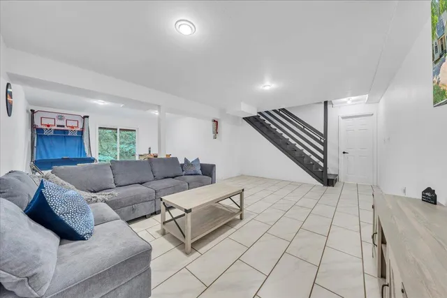 a living room with furniture and a ceiling fan