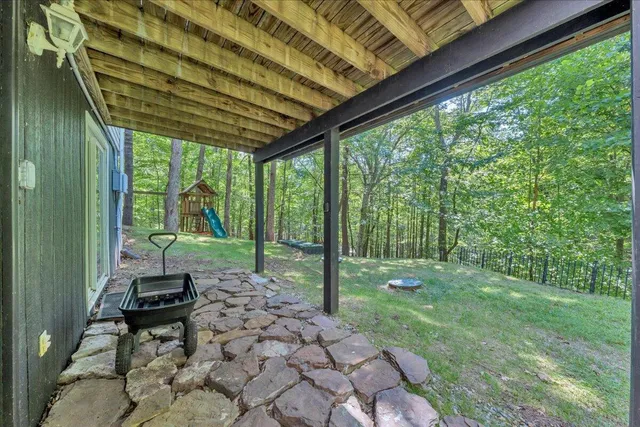 a view of sitting area on roof deck with furniture and wooden floor