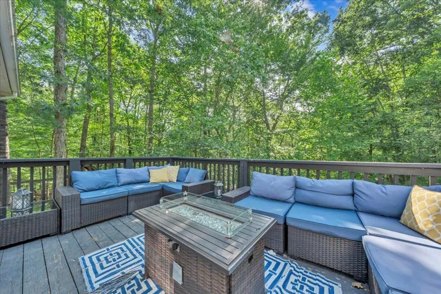 a roof deck with couches and wooden floor