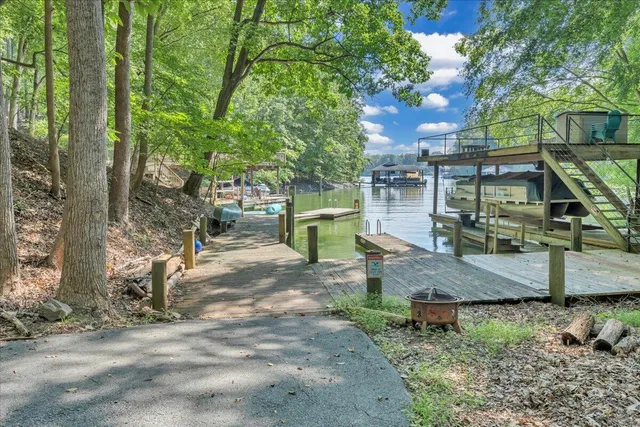 an aerial view of a residential houses with outdoor space and lake view