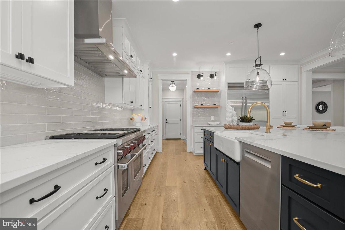 204 Oxford Street Chevy Chase, MD 20815 - Photo 15 of 59 a large kitchen with stainless steel appliances granite countertop a lot of counter space and wooden floors
