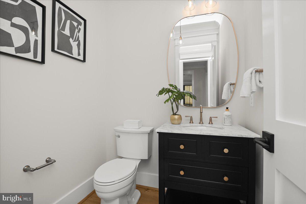 204 Oxford Street Chevy Chase, MD 20815 - Photo 28 of 59 a bathroom with a toilet a sink and mirror