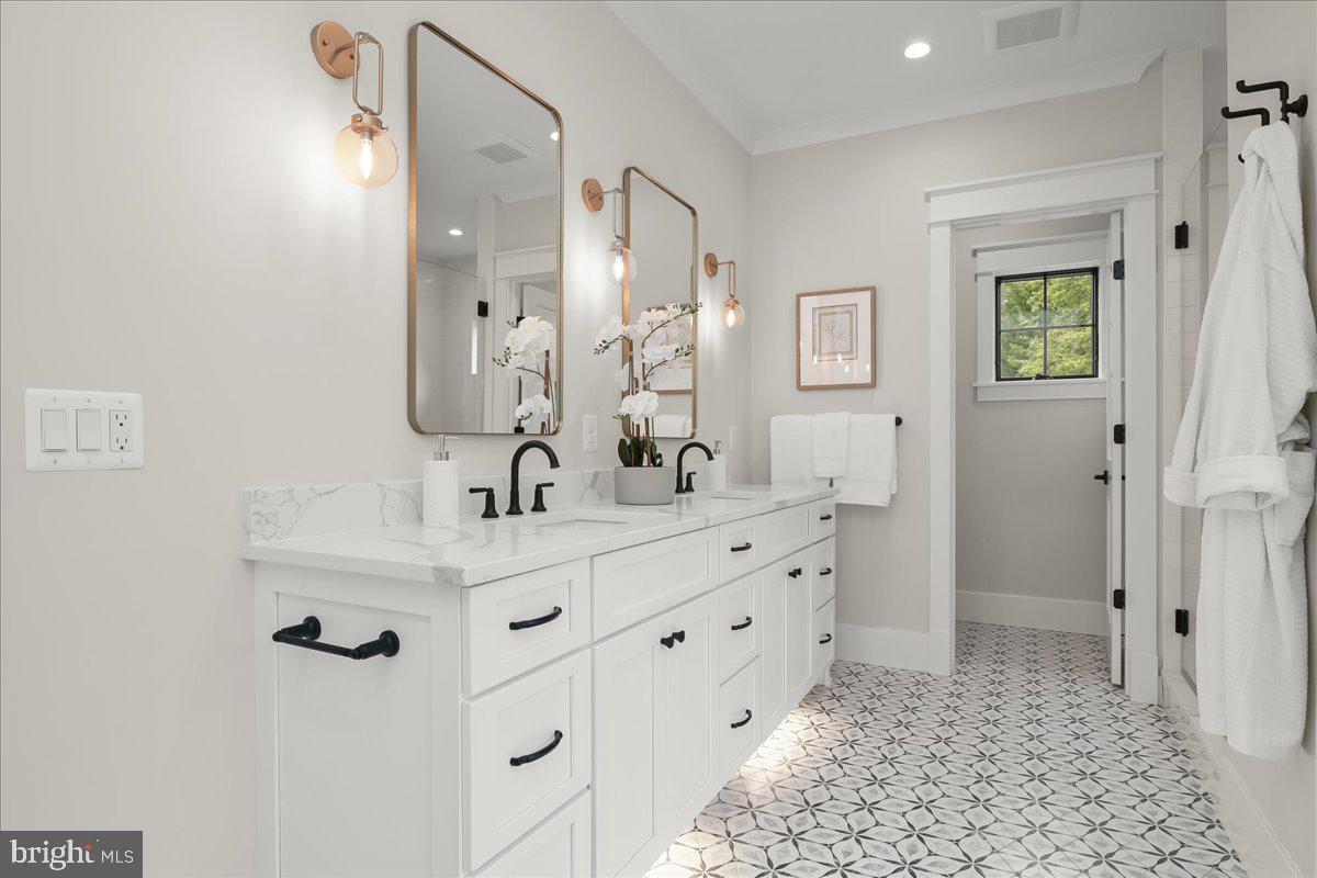 204 Oxford Street Chevy Chase, MD 20815 - Photo 39 of 59 a bathroom with a double vanity sink mirror and shower