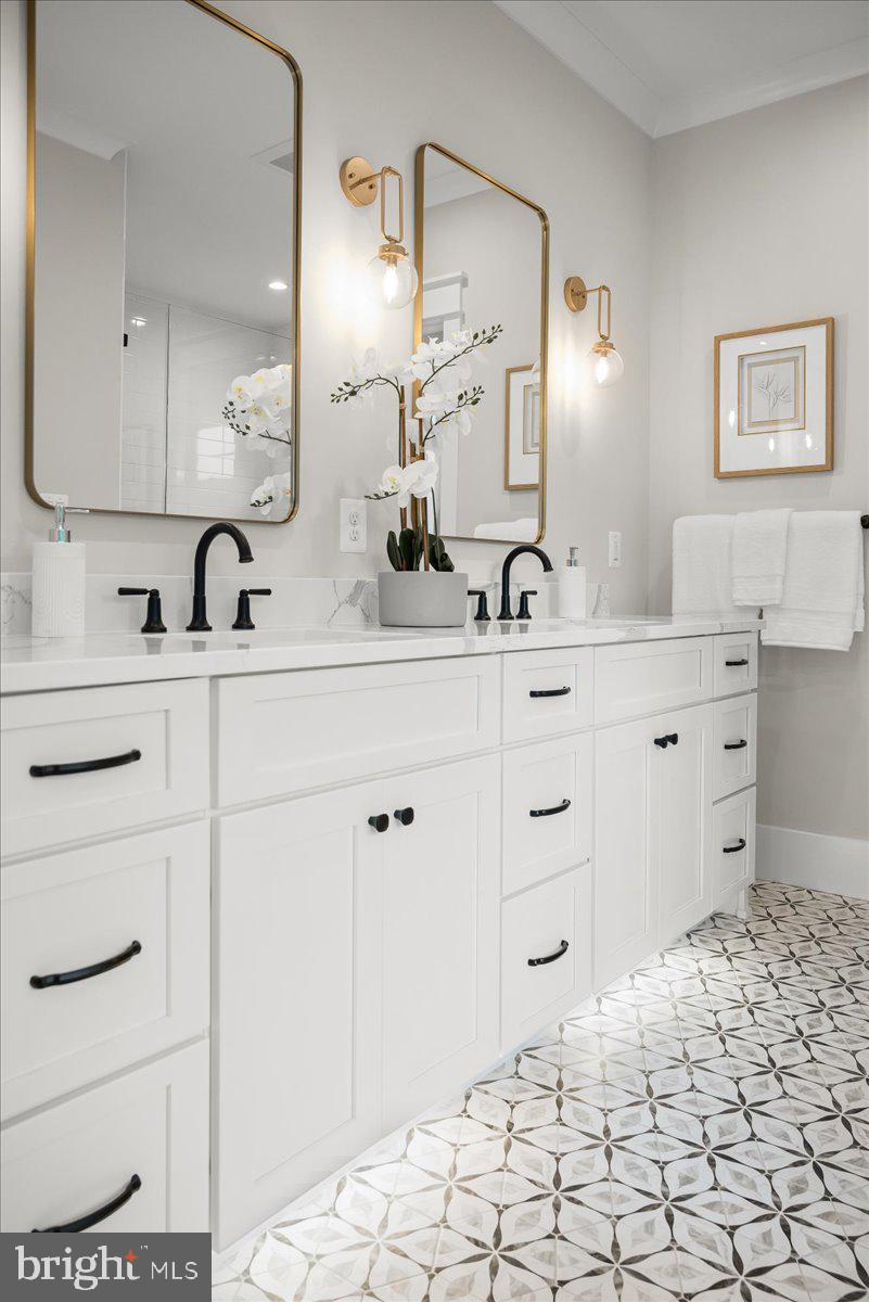 204 Oxford Street Chevy Chase, MD 20815 - Photo 42 of 59 a bathroom with a sink and a mirror