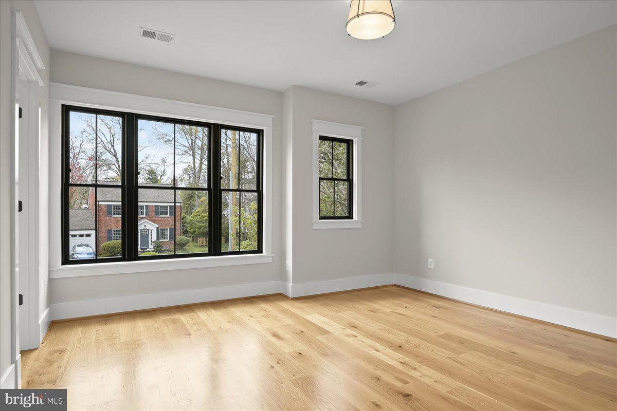 204 Oxford Street Chevy Chase, MD 20815 - Photo 46 of 59 a view of an empty room with a window and wooden floor