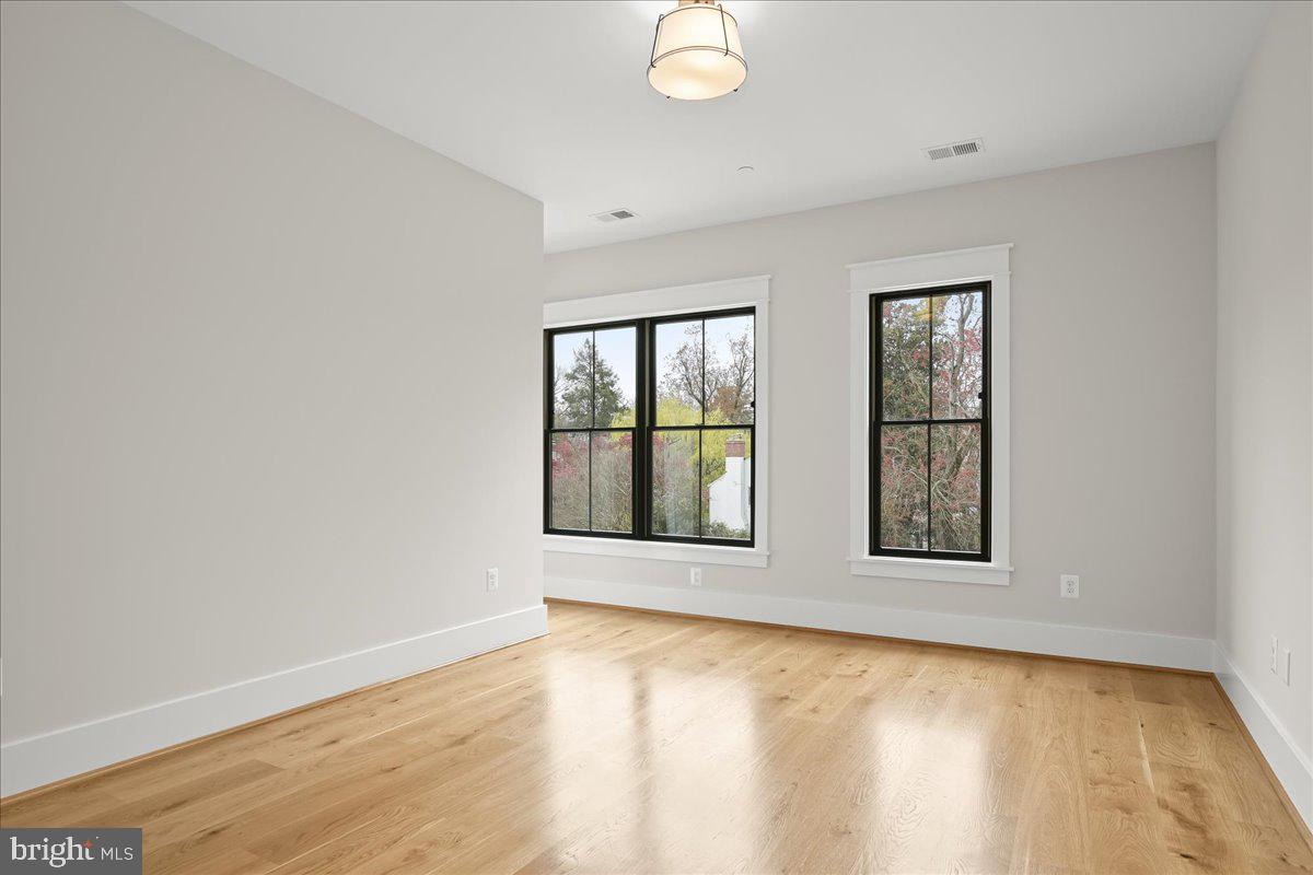 204 Oxford Street Chevy Chase, MD 20815 - Photo 48 of 59 an empty room with wooden floor and windows