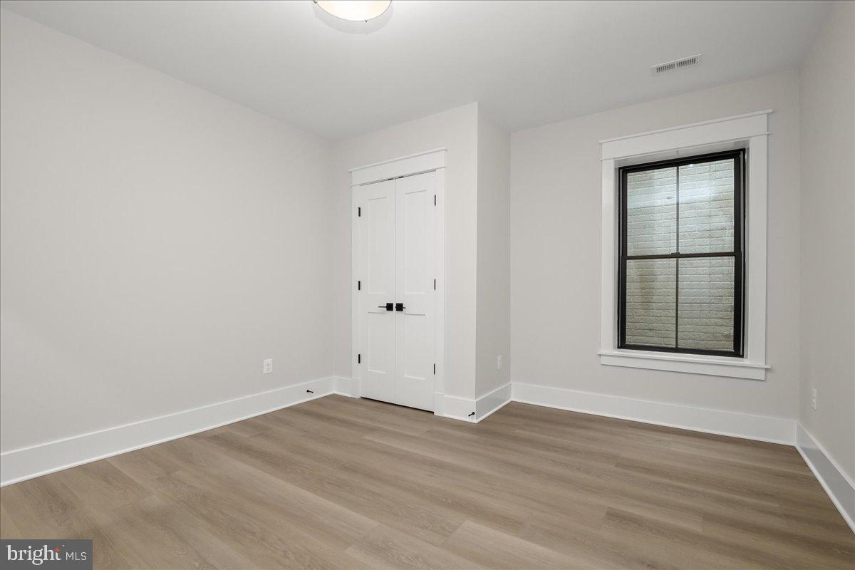 204 Oxford Street Chevy Chase, MD 20815 - Photo 58 of 59 an empty room with wooden floor and windows