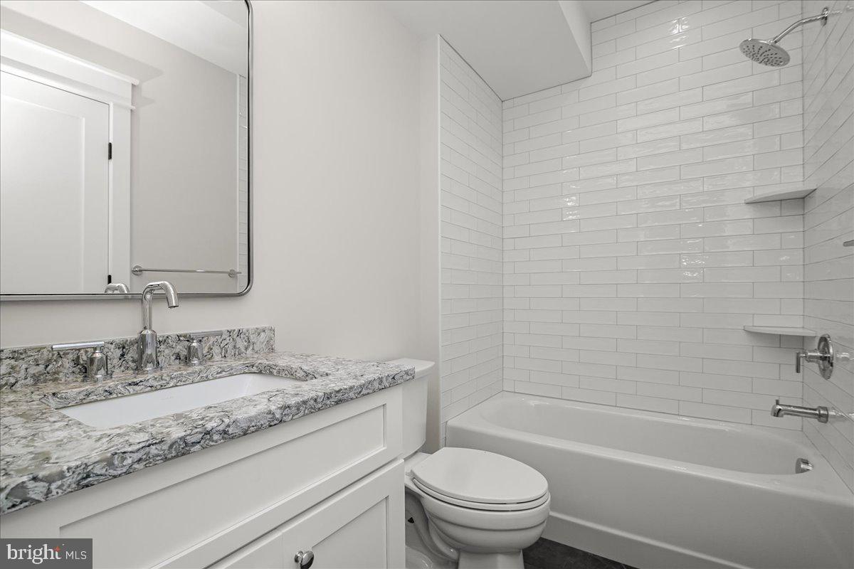 204 Oxford Street Chevy Chase, MD 20815 - Photo 59 of 59 a bathroom with a granite countertop sink a toilet and bathtub