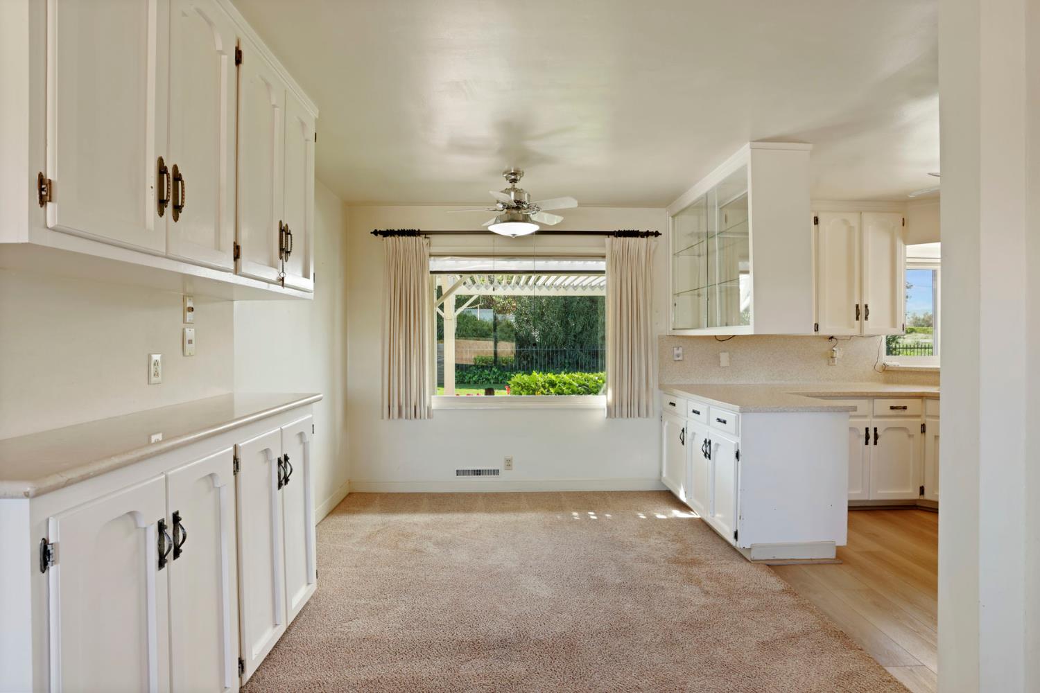 2465 Vernalis Road Tracy, CA 95304 - Photo 12 of 55 a kitchen with granite countertop a stove a sink and a refrigerator with white cabinets