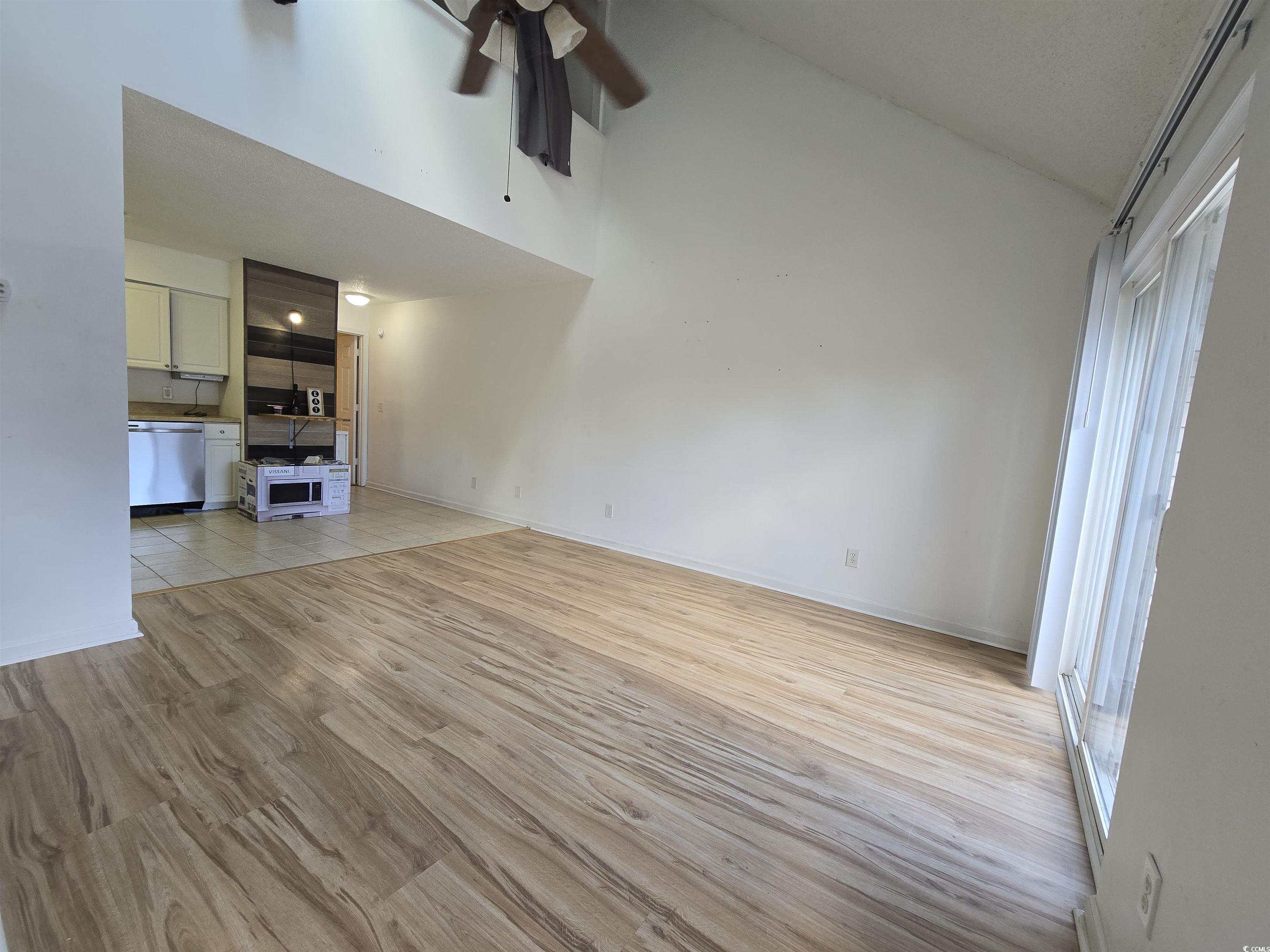 F6 Cambridge Circle, Unit F6 Murrells Inlet, SC 29576 - Photo 3 of 15 Unfurnished living room featuring ceiling fan, vau