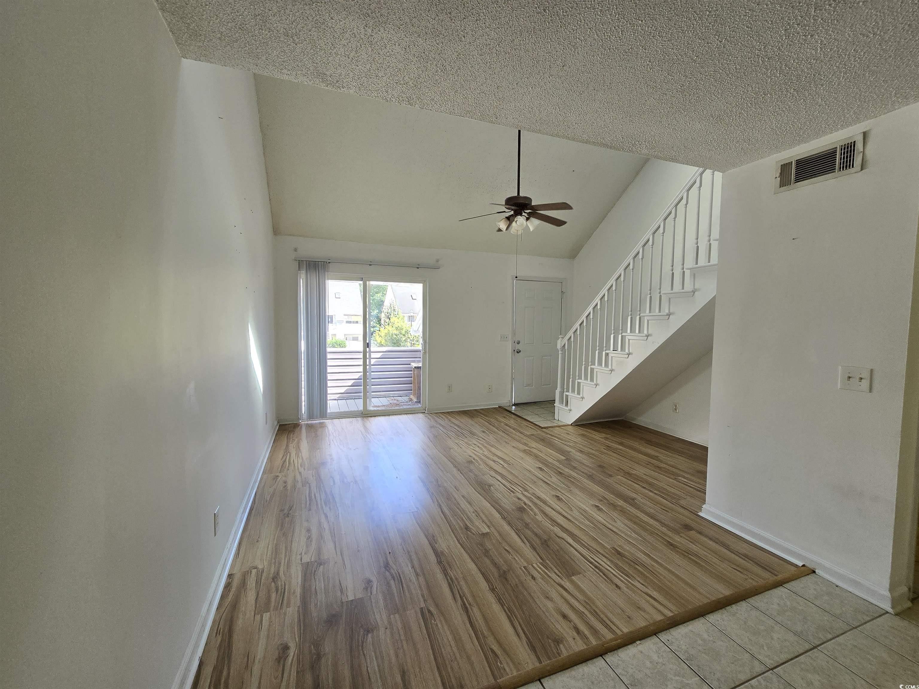 F6 Cambridge Circle, Unit F6 Murrells Inlet, SC 29576 - Photo 4 of 15 Unfurnished living room with ceiling fan, high vau