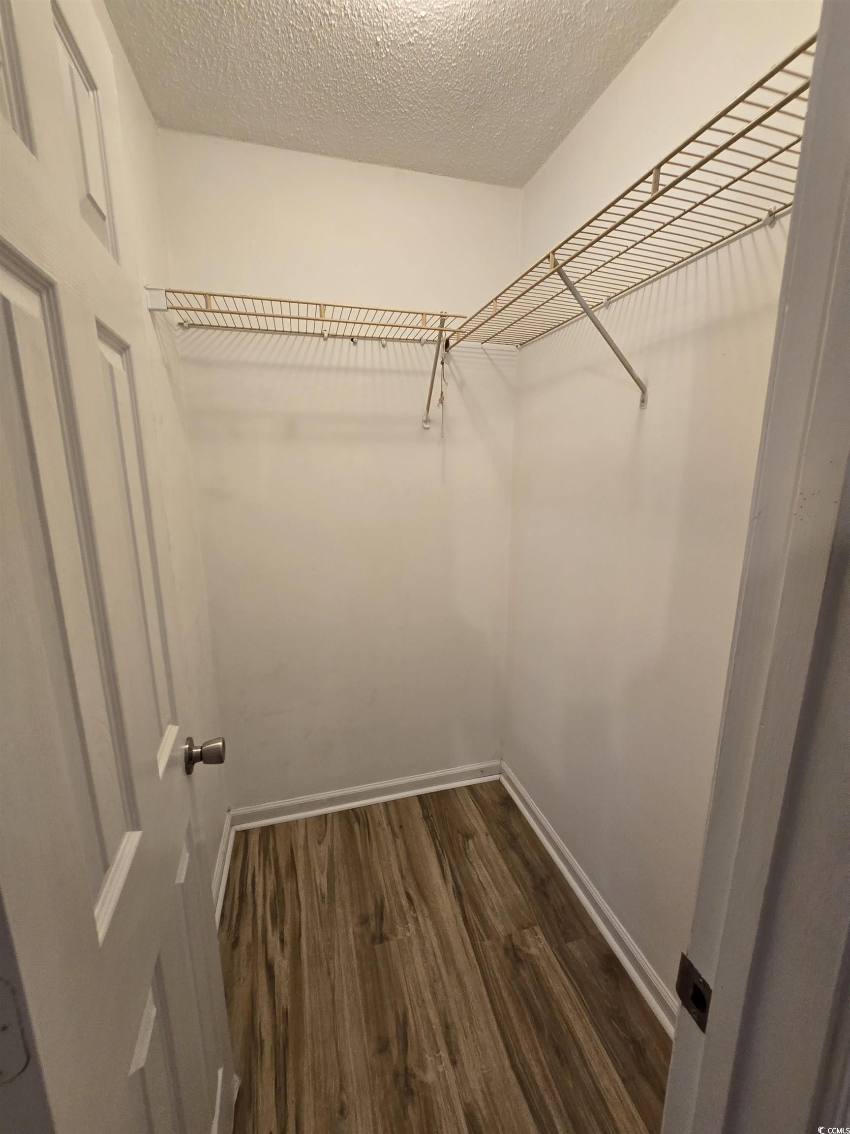 F6 Cambridge Circle, Unit F6 Murrells Inlet, SC 29576 - Photo 9 of 15 Walk in closet with hardwood / wood-style flooring