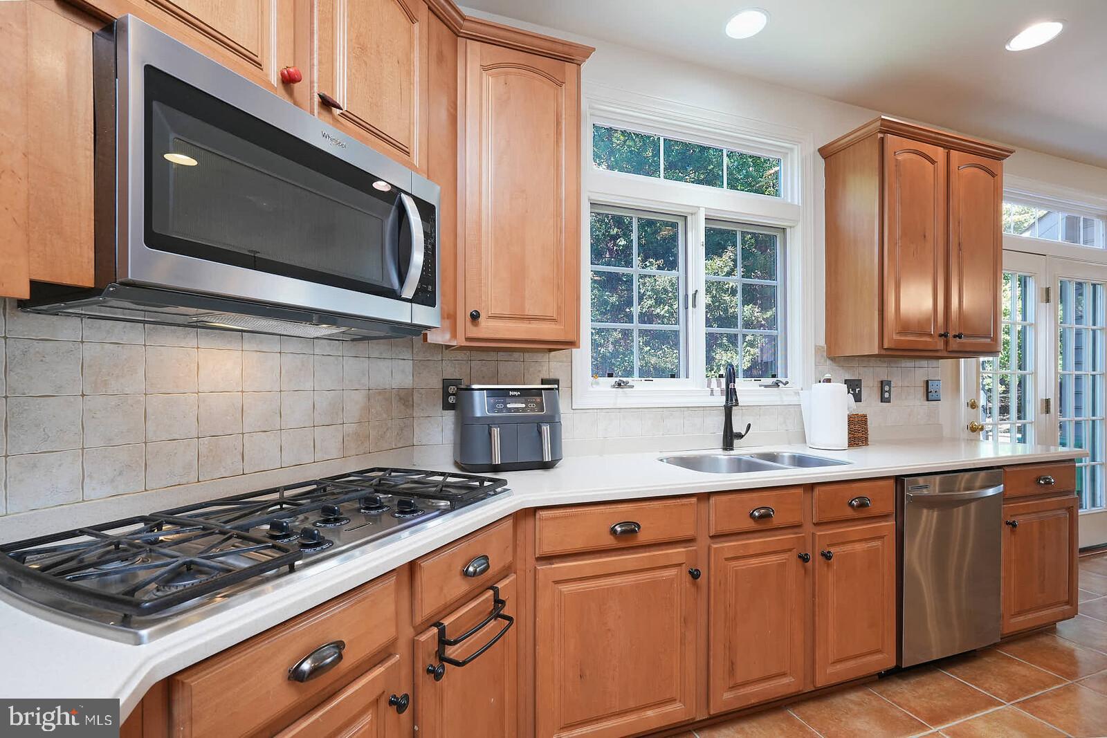 13014 English Turn Drive Silver Spring, MD 20904 - Photo 14 of 62 a kitchen with granite countertop a stove sink and microwave