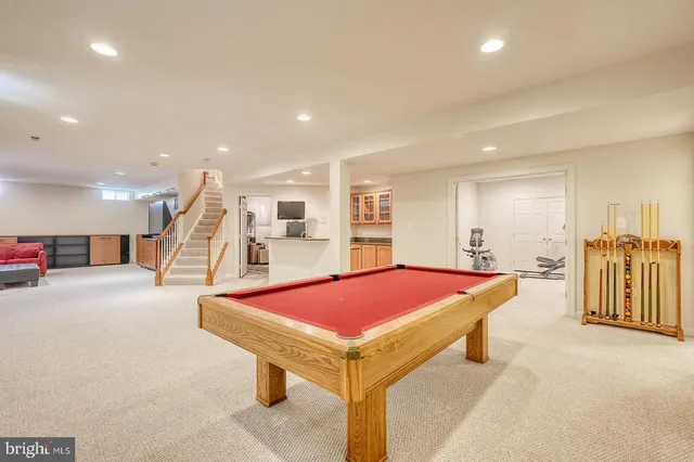 a large kitchen with kitchen island granite countertop a stove a sink and a granite counter tops