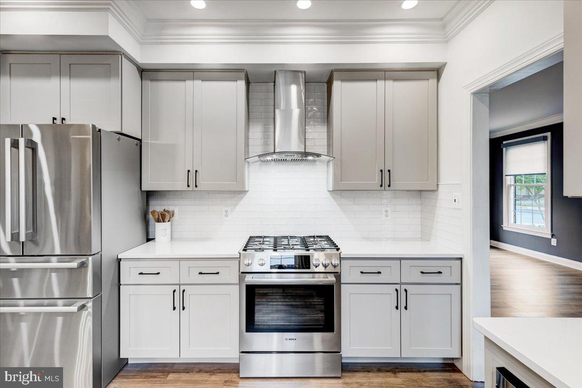 43501 Monarch Beach Square Leesburg, VA 20176 - Photo 11 of 43 a kitchen with stainless steel appliances white cabinets and wooden floors