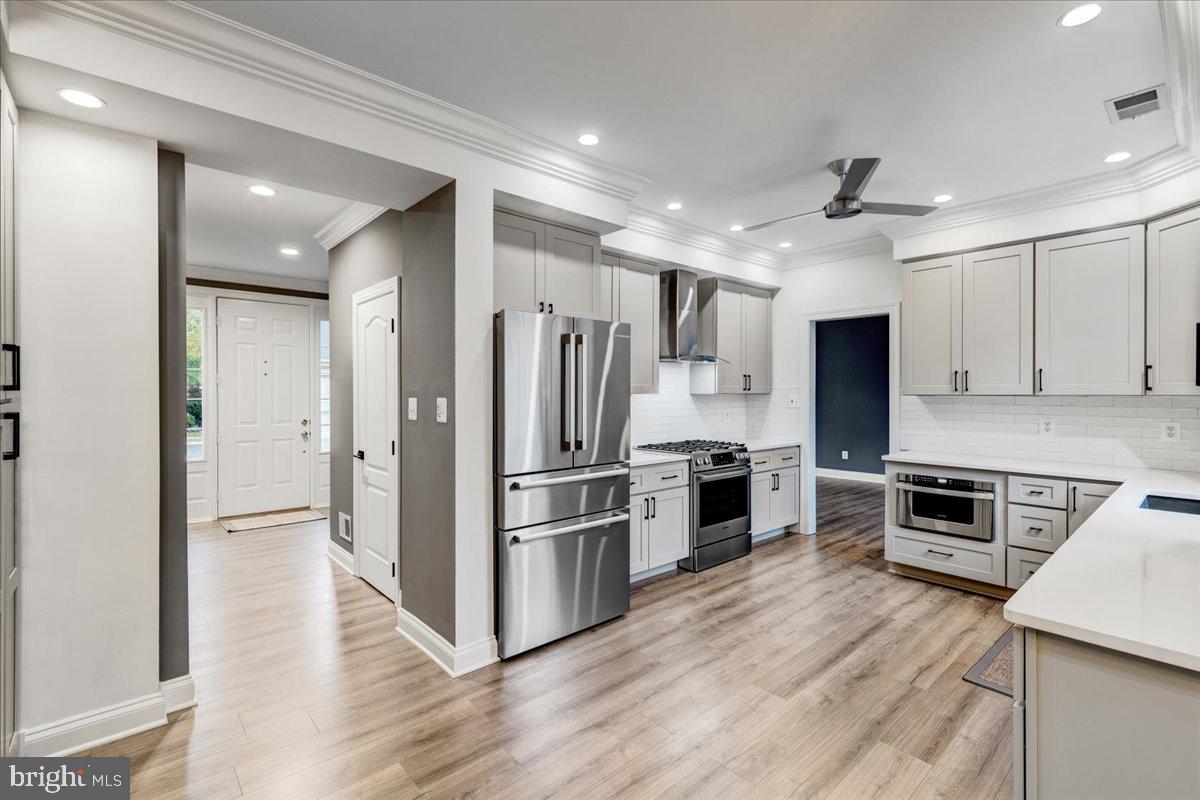 43501 Monarch Beach Square Leesburg, VA 20176 - Photo 14 of 43 a kitchen with a refrigerator a stove top oven and kitchen island