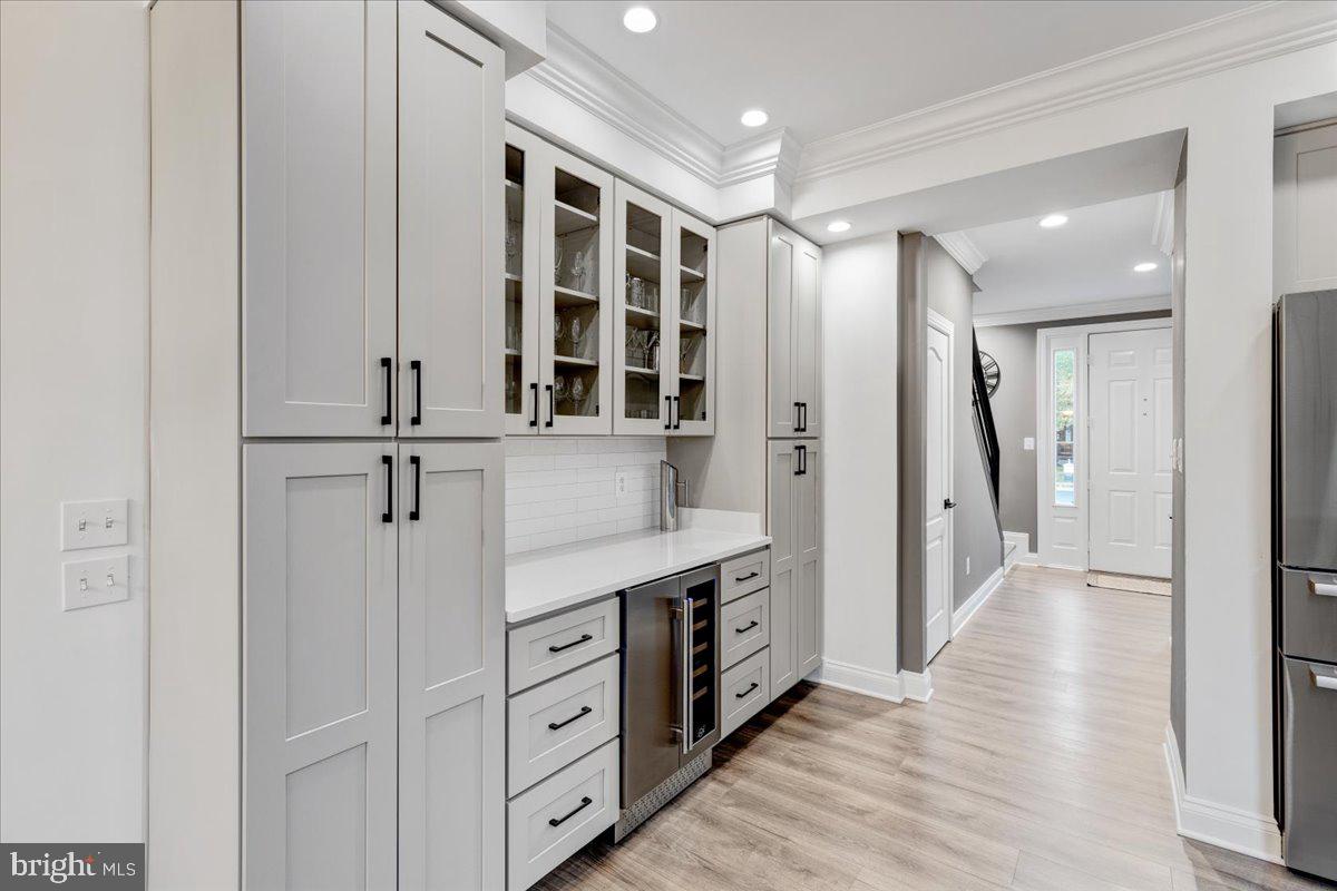 43501 Monarch Beach Square Leesburg, VA 20176 - Photo 15 of 43 a view of a hallway with wooden floor and cabinet