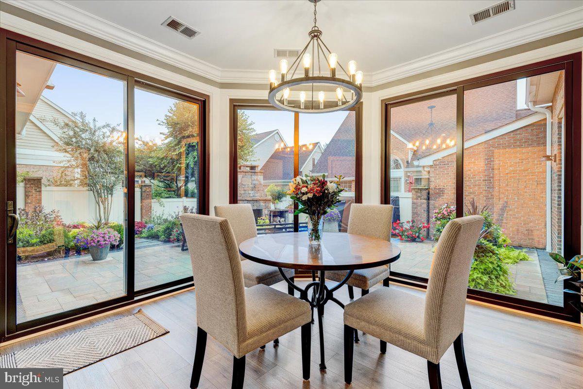 43501 Monarch Beach Square Leesburg, VA 20176 - Photo 16 of 43 a dining room with furniture a chandelier and wooden floor