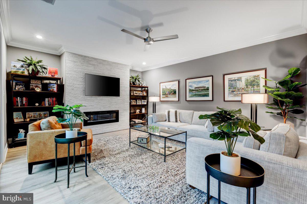 43501 Monarch Beach Square Leesburg, VA 20176 - Photo 19 of 43 a living room with furniture a chandelier and a flat screen tv