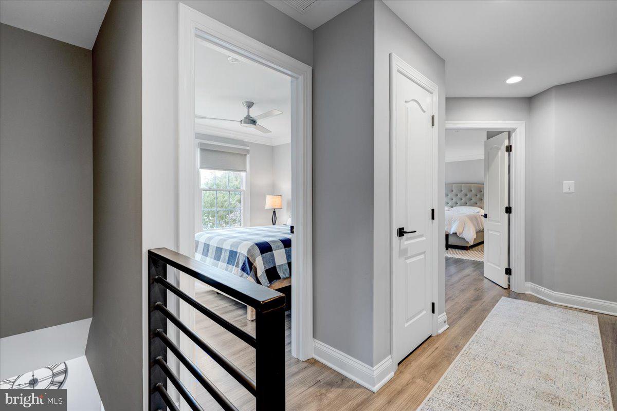 43501 Monarch Beach Square Leesburg, VA 20176 - Photo 23 of 43 a view of a hallway and a livingroom with wooden floor and a bedroom