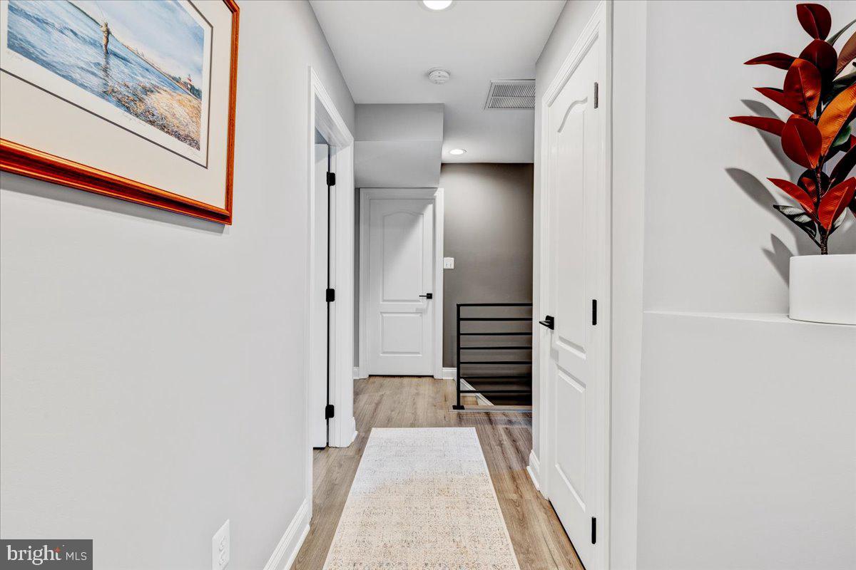 43501 Monarch Beach Square Leesburg, VA 20176 - Photo 30 of 43 a view of a hallway with wooden floor and entryway