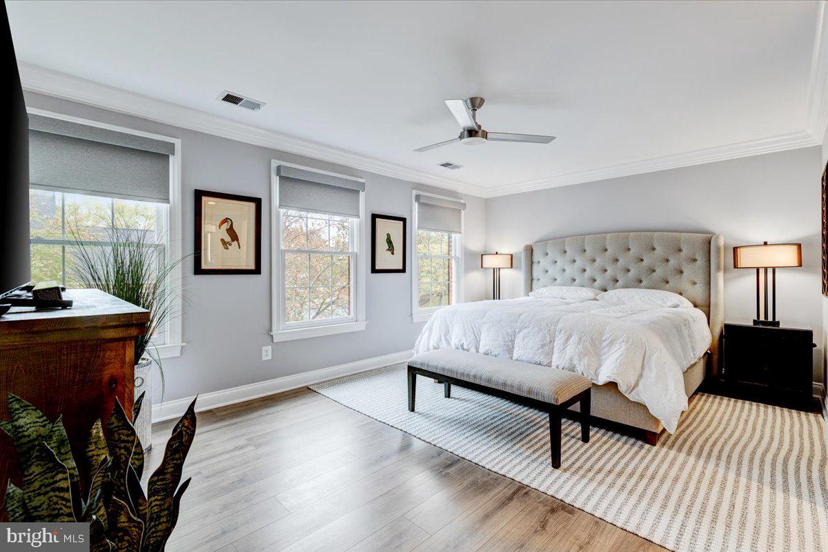 43501 Monarch Beach Square Leesburg, VA 20176 - Photo 31 of 43 a bed sitting in a spacious bedroom next to a window and a lamp