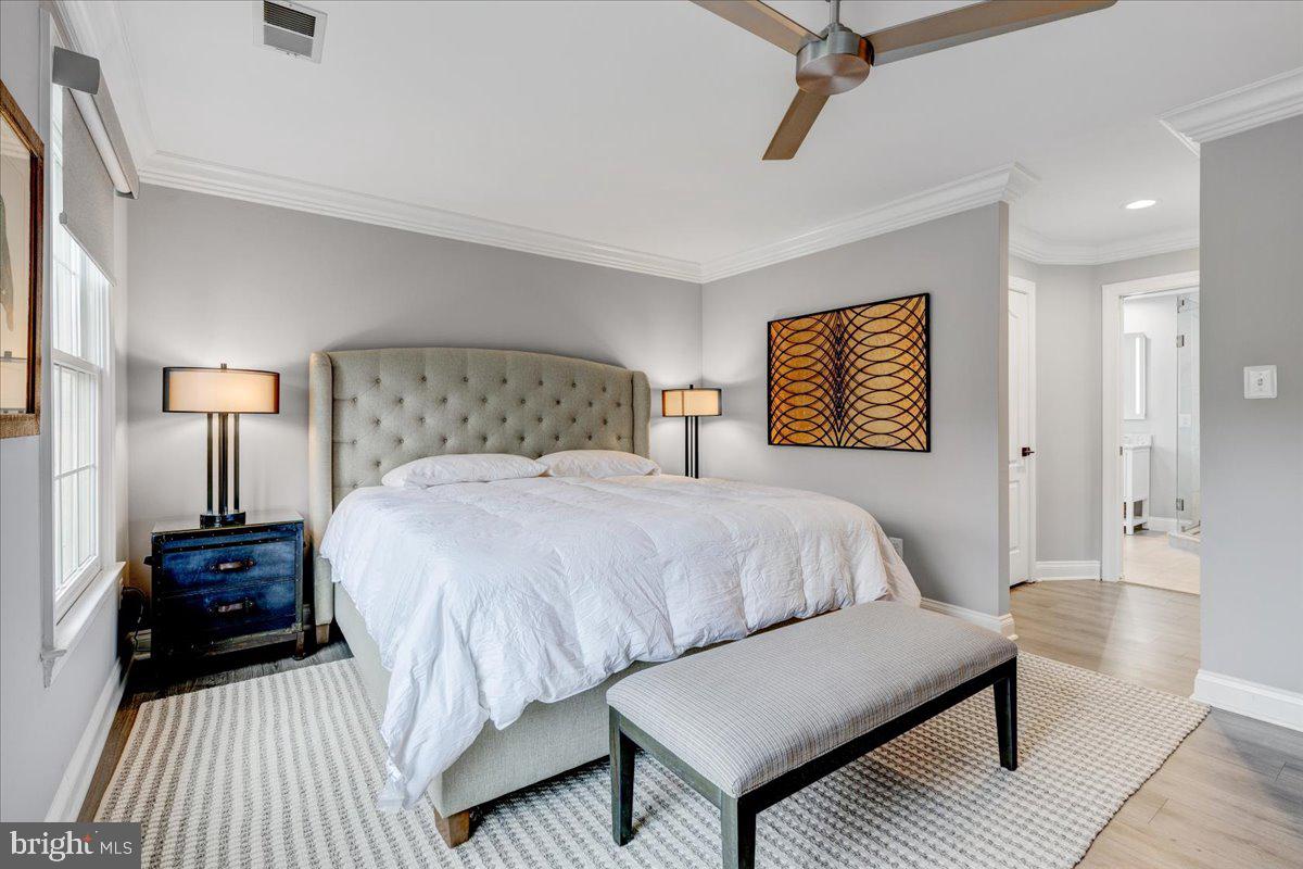 43501 Monarch Beach Square Leesburg, VA 20176 - Photo 32 of 43 a bedroom with a bed and wooden floor