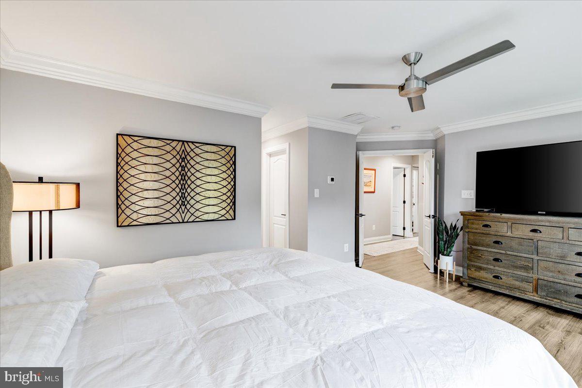 43501 Monarch Beach Square Leesburg, VA 20176 - Photo 33 of 43 a bedroom with a bed and a flat screen tv
