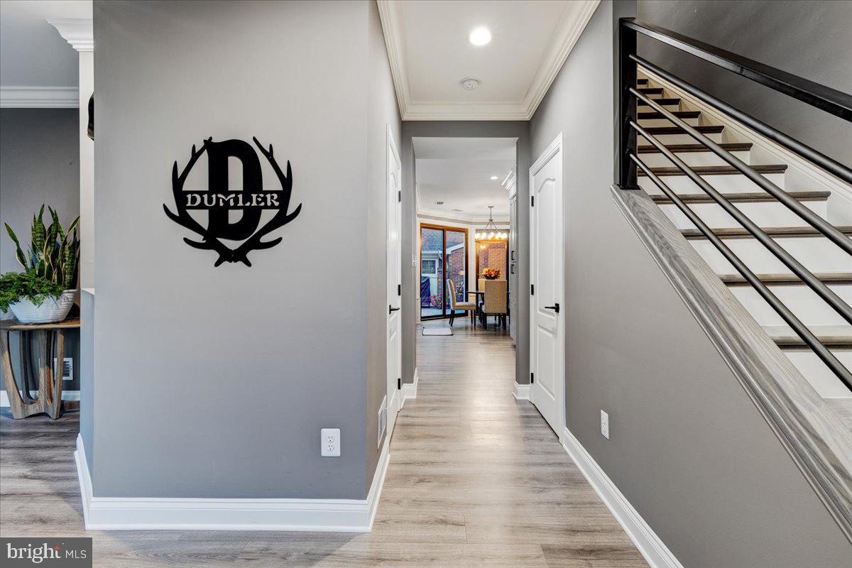 43501 Monarch Beach Square Leesburg, VA 20176 - Photo 4 of 43 a view of a hallway with wooden floor and staircase
