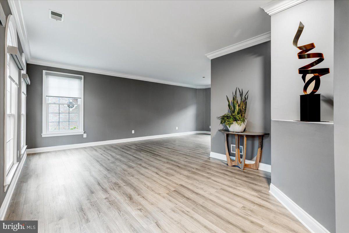 43501 Monarch Beach Square Leesburg, VA 20176 - Photo 5 of 43 wooden floor in an empty room with a window
