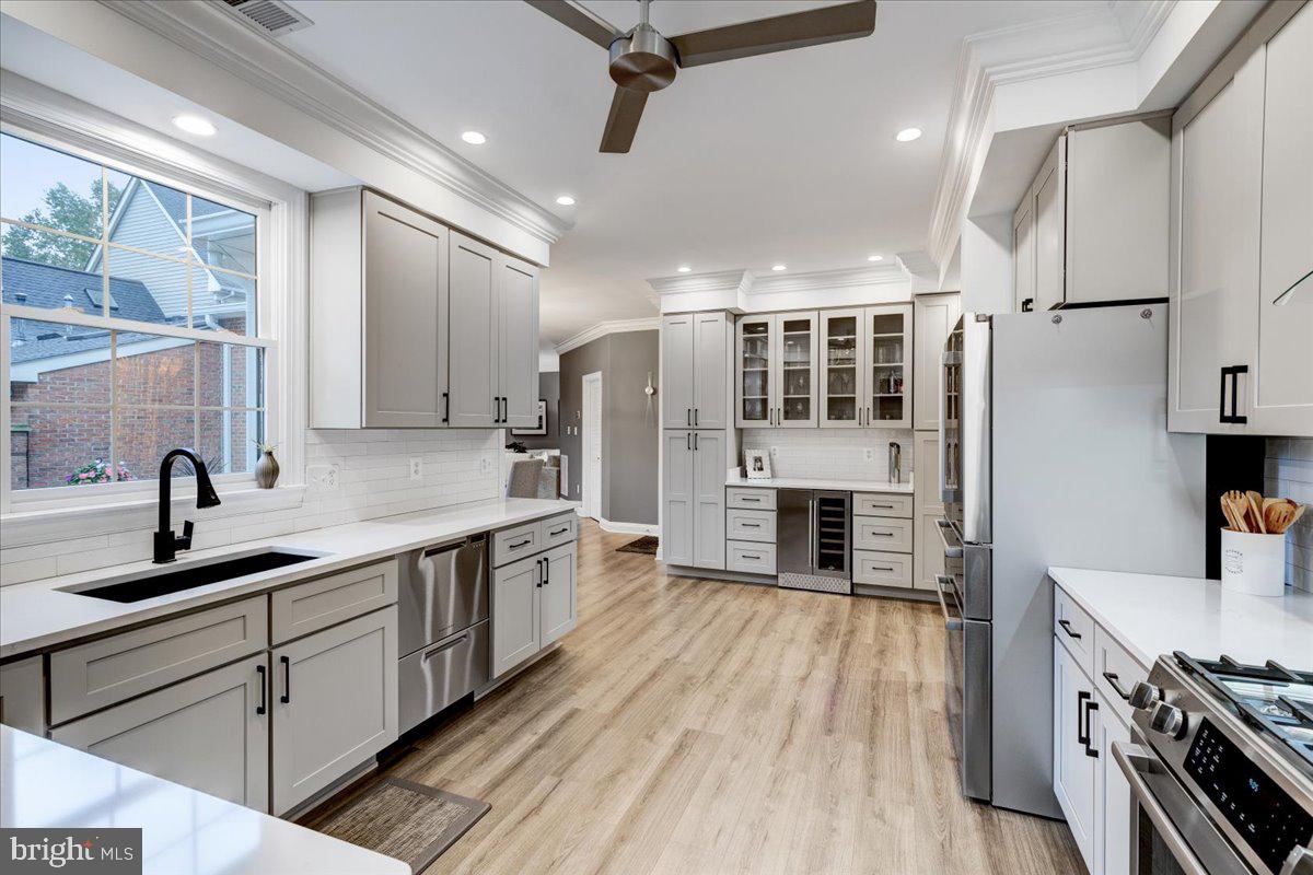 43501 Monarch Beach Square Leesburg, VA 20176 - Photo 9 of 43 a kitchen with stainless steel appliances a sink dishwasher a refrigerator and a stove with wooden floor