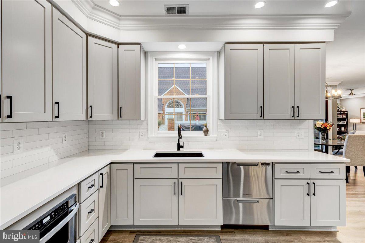 43501 Monarch Beach Square Leesburg, VA 20176 - Photo 10 of 43 a kitchen with white cabinets and a sink