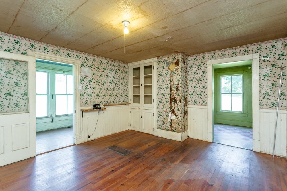 253 Church Street Timberville, VA 22853 - Photo 10 of 24 an empty room with wooden floor and windows