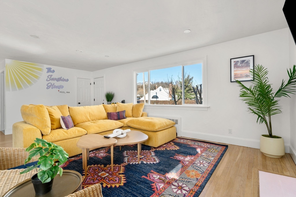 30 Coburn Street Hull, MA 02045 - Photo 16 of 39 a living room with furniture and a potted plant