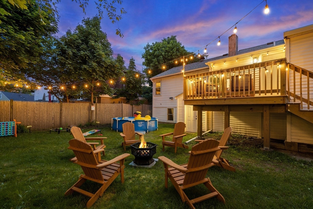 30 Coburn Street Hull, MA 02045 - Photo 4 of 39 a couple of blue chairs sitting in a yard with swimming pool in the back