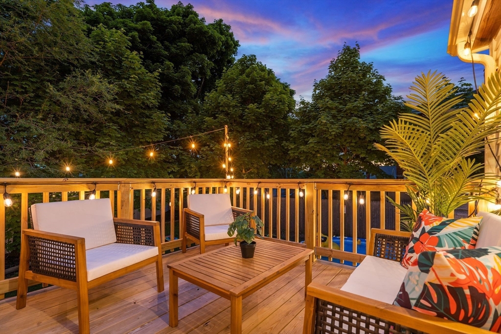 30 Coburn Street Hull, MA 02045 - Photo 5 of 39 a roof deck with a dining table and chairs with wooden floor