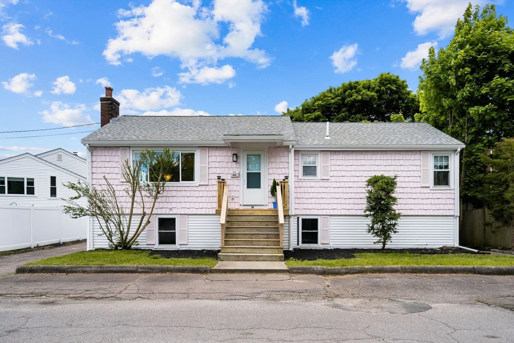 30 Coburn Street Hull, MA 02045 - Photo 6 of 39 a front view of a house with a yard and potted plants
