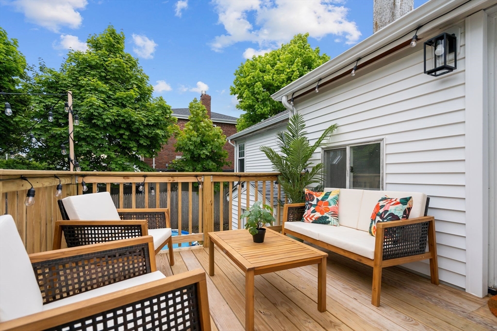 30 Coburn Street Hull, MA 02045 - Photo 8 of 39 a view of a patio with couches chairs and wooden floor