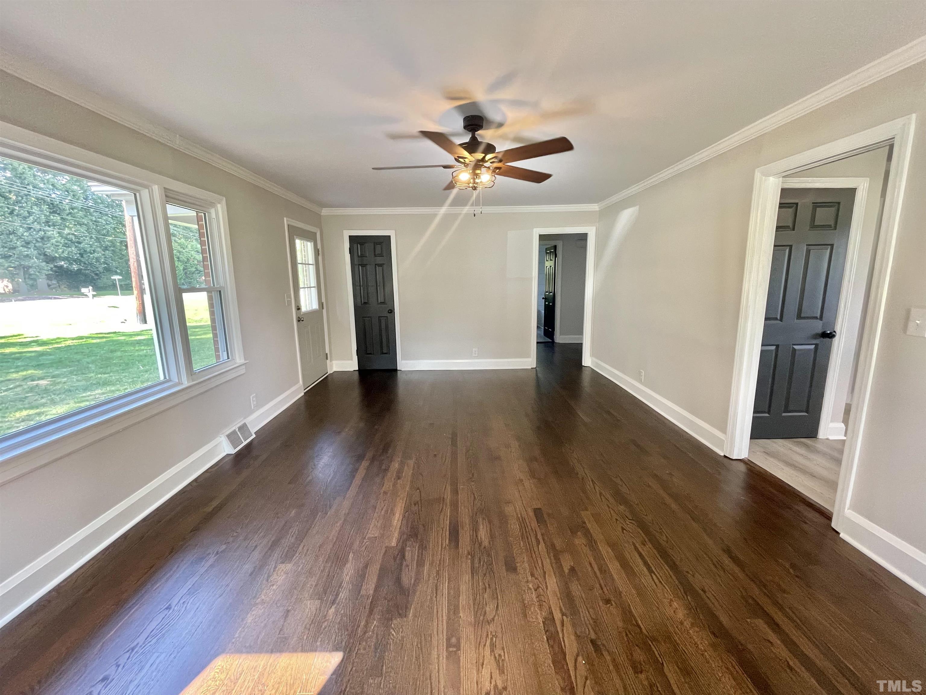 2221 Burlington Road Roxboro, NC 27574 - Photo 11 of 28 a view of an empty room with wooden floor and a window