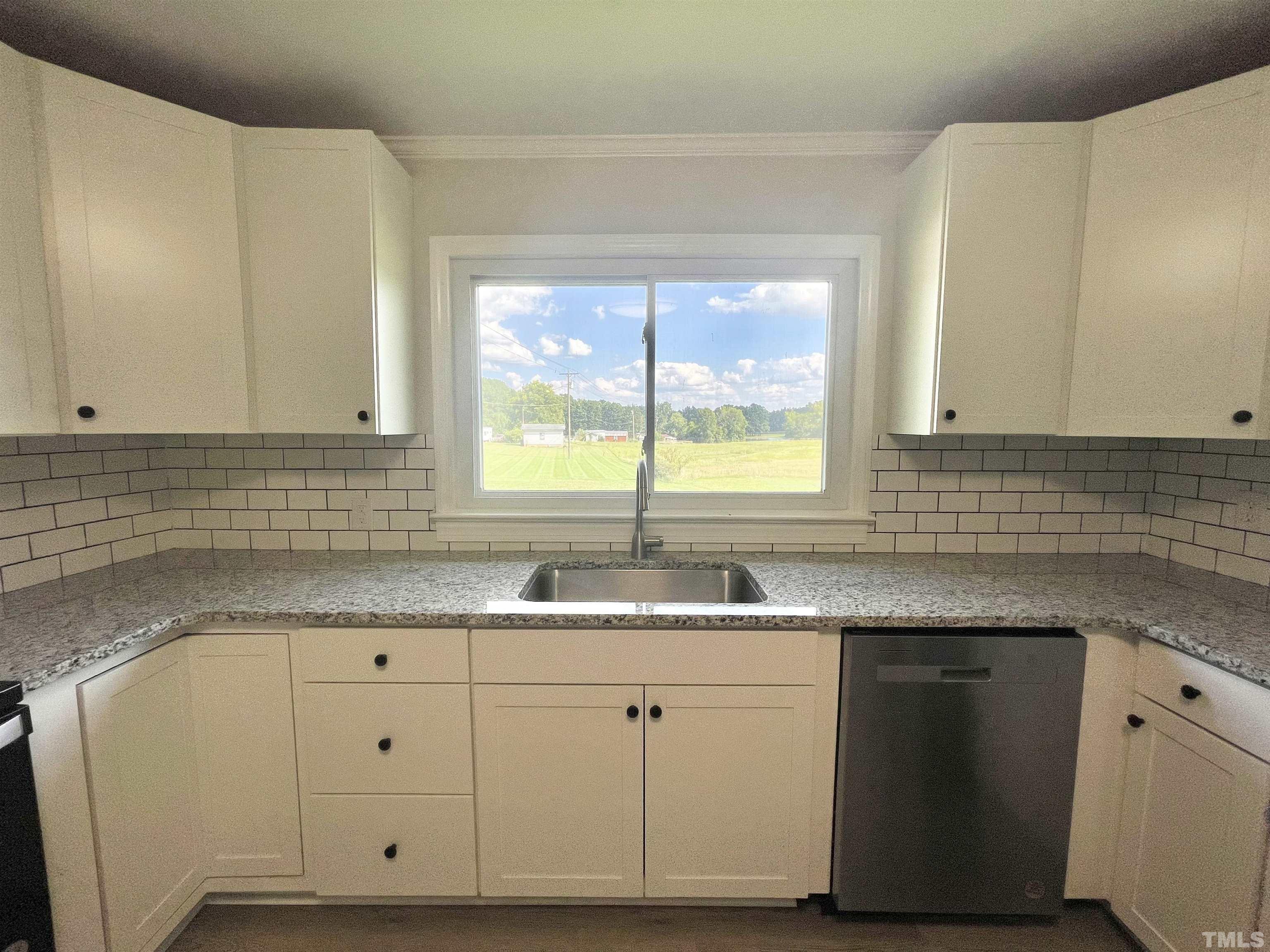 2221 Burlington Road Roxboro, NC 27574 - Photo 7 of 28 a kitchen with granite countertop white cabinets and a sink