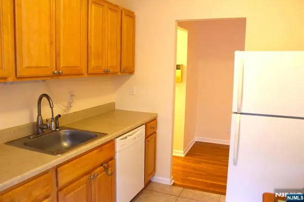 a kitchen with a sink and a refrigerator