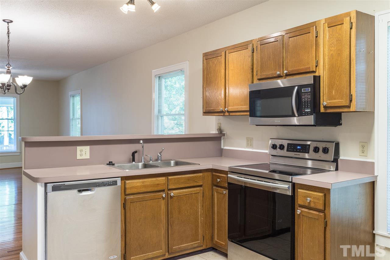 507 Pace Street Raleigh, NC 27604 - Photo 13 of 25 a kitchen with stainless steel appliances a stove sink microwave and cabinets