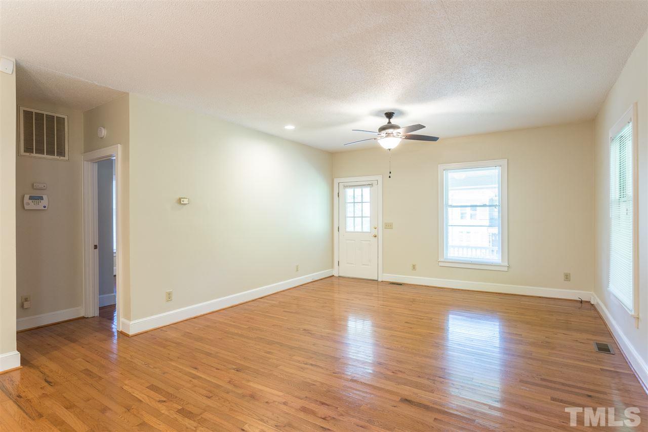 507 Pace Street Raleigh, NC 27604 - Photo 4 of 25 a view of an empty room with a window and wooden floor