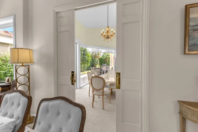 a living room with furniture a flat screen tv and a floor to ceiling window